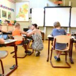 Children Sitting on Brown Chairs Inside the Classroom