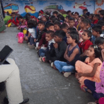 Dr. Anil Mokashi telling stories to children
