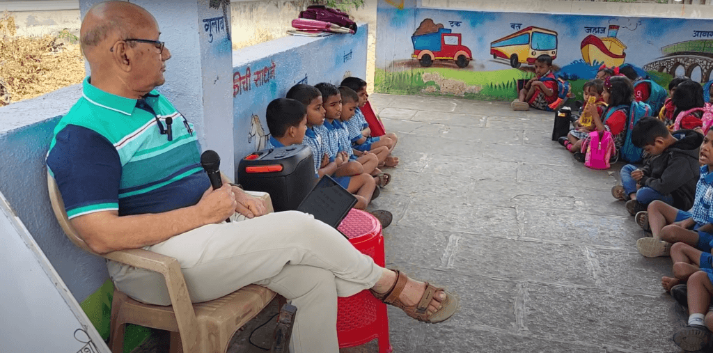 Dr. Anil Mokashi telling stories to children